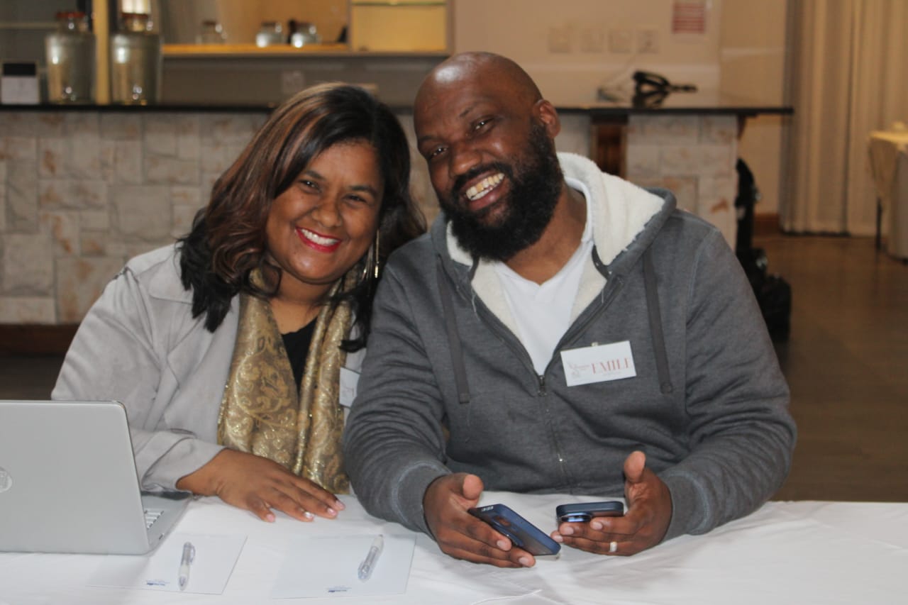 Emile and Leticia from Arnon and Gila Practitioners seated together in a warm professional setting